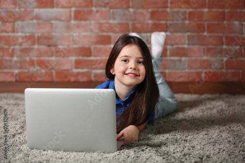 Little girl with laptop on ...
