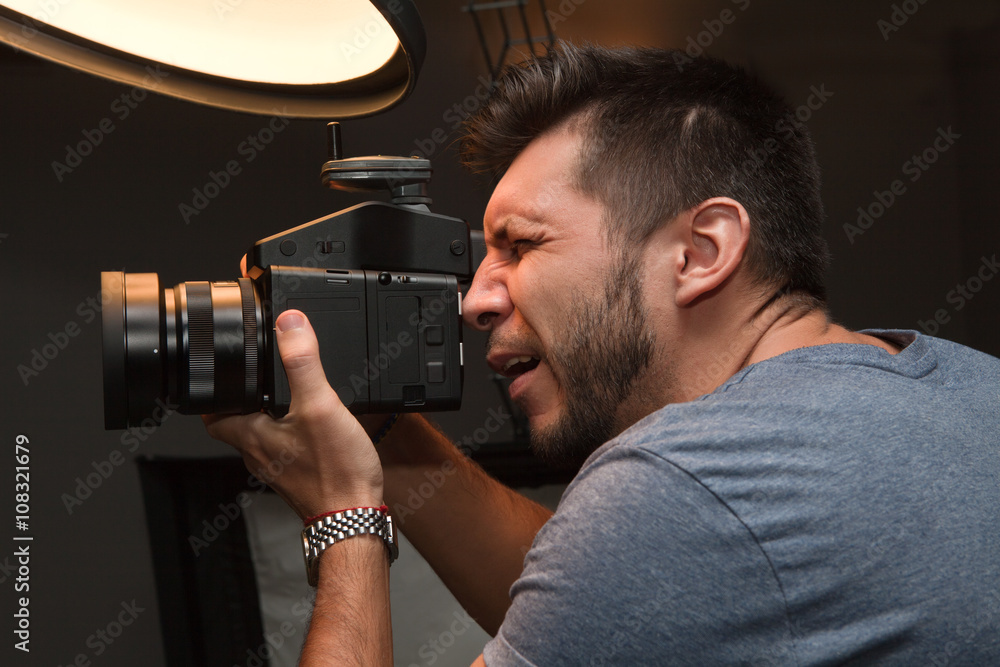 Fototapeta premium photographer with a medium format camera in the studio