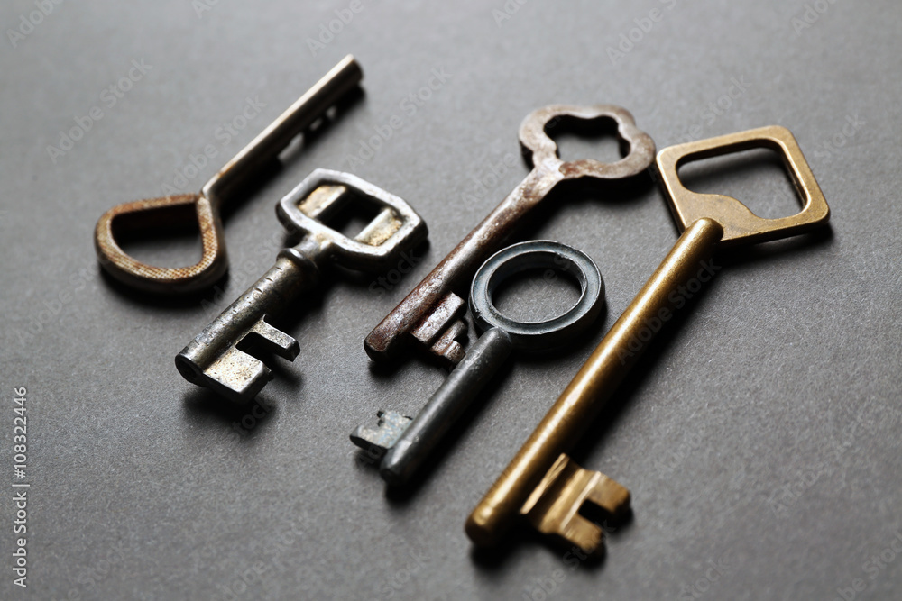 Group of old keys on grey textured background Group of old keys on grey textured background