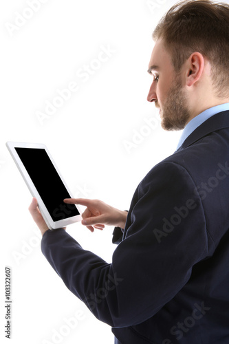 Young man in suit using tab...