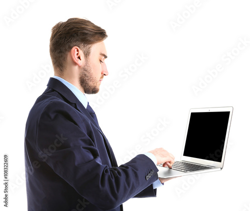 Young man in suit using lap...