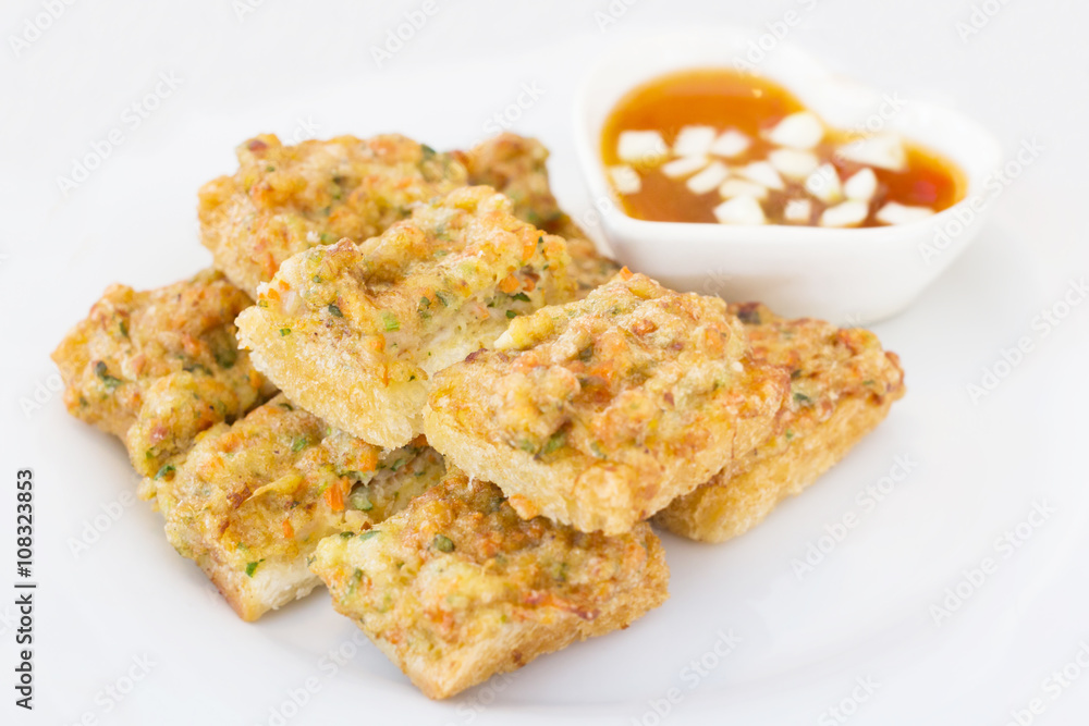 Fried bread with minced pork spread (Thai food) on white plate