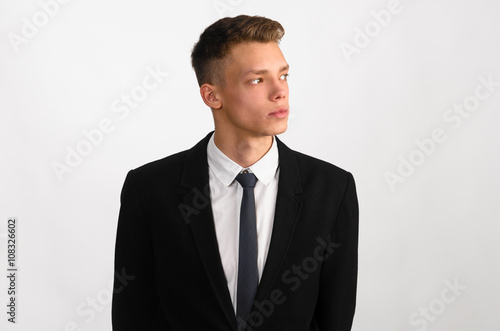 portrait of young stylish businessman on gray background