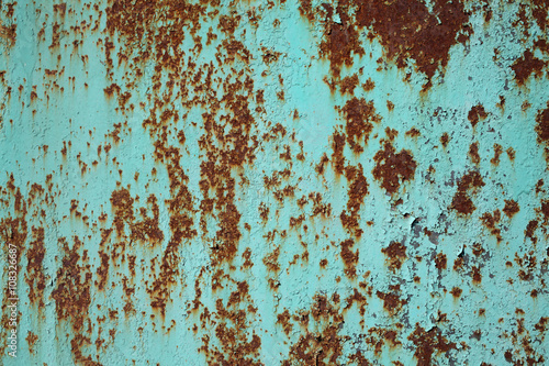 rusted on the cyan green metal wall . background and texture for your design.