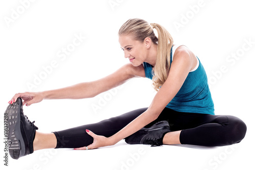Fit woman stretching while exercising