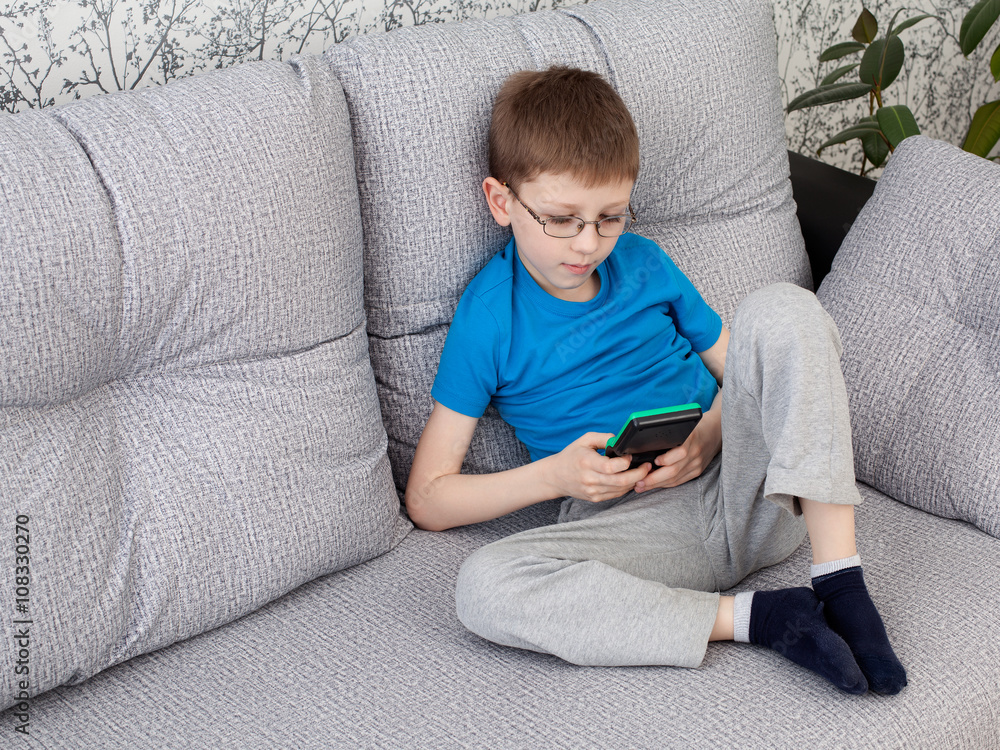boy playing on a console boy playing on a console