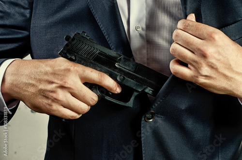 man in suit holding gun © Sarka