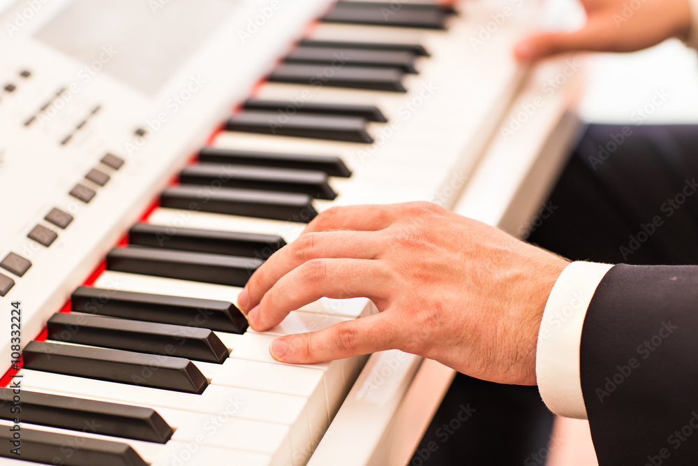 Hands of musician close-up. Pianist playing on electric piano Hands of musician close-up. Pianist playing on electric piano