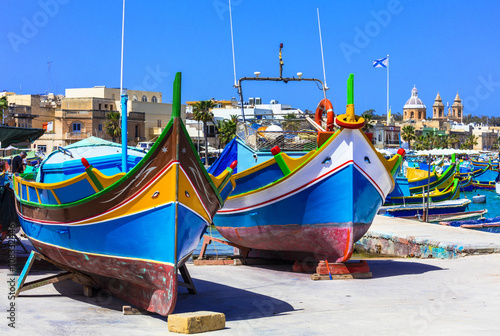 traditional colorful fishing boats luzzu in Malta - Marsaxlokk village photo
