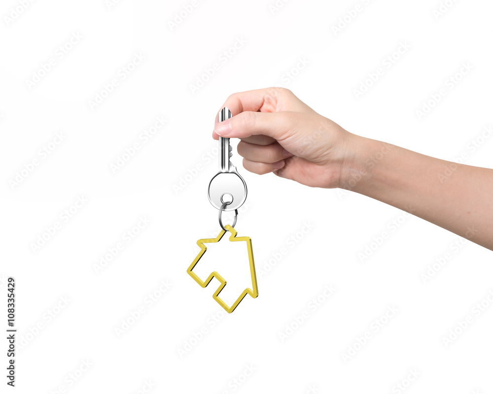 Woman hand holding key with house shape keyring Woman hand holding key with house shape keyring