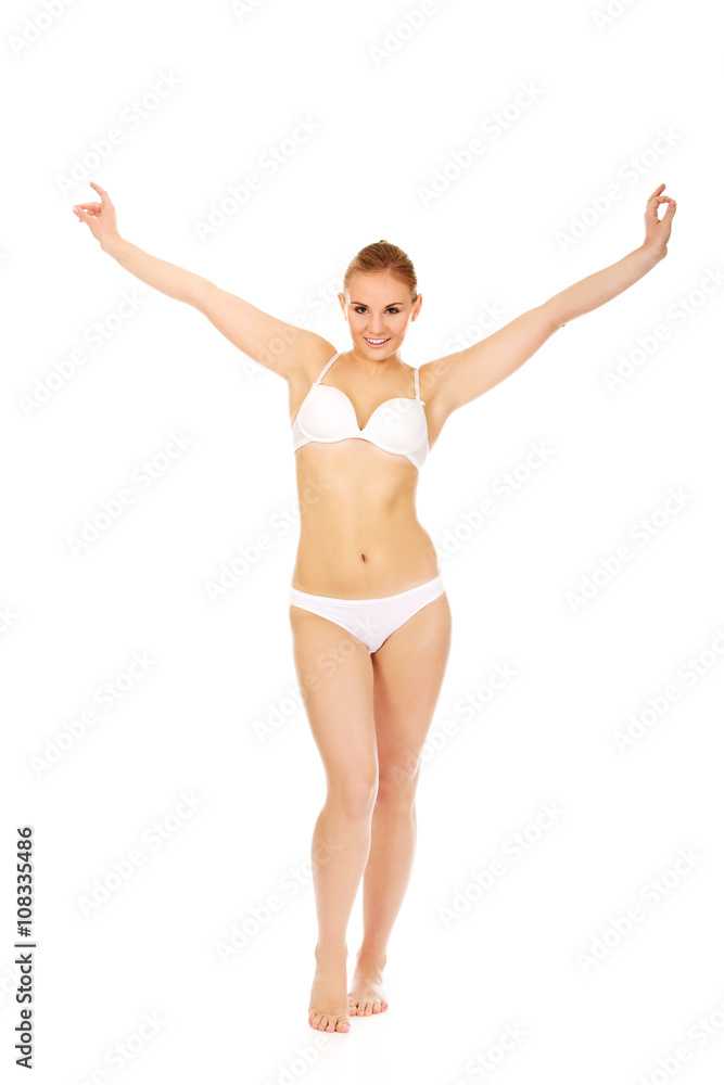 Happy young woman in white underwear holds her arms up Happy young woman in white underwear holds her arms up