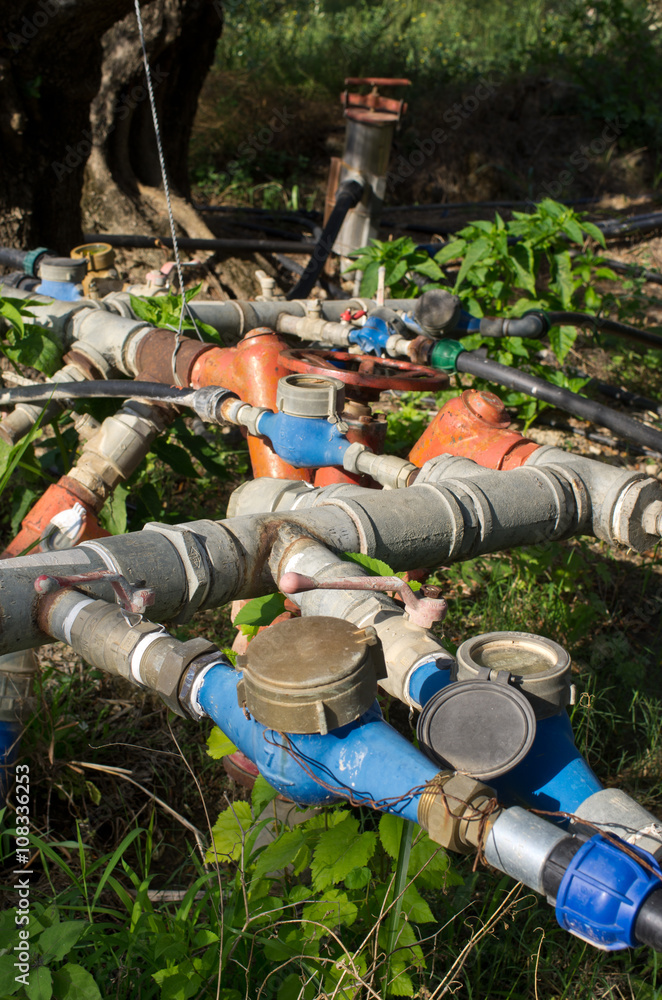 Fototapeta premium Hydraulic valves on olive plantation, Greece