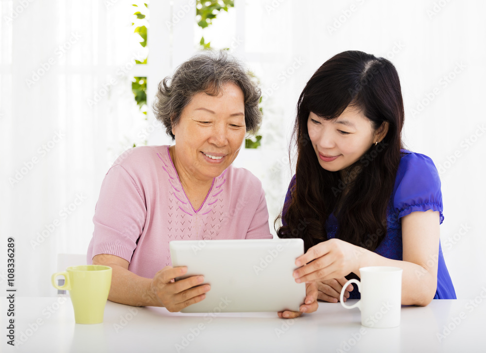 happy senior Mother and daughter learning tablet pc happy senior Mother and daughter learning tablet pc