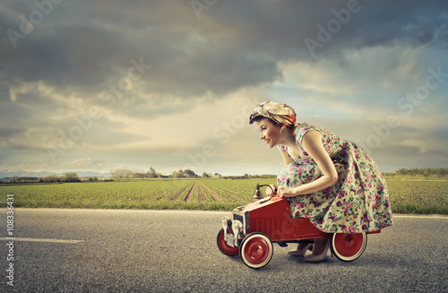 Woman driving a toy car