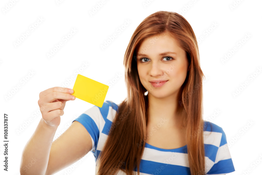 Teenage woman holding empty business card Teenage woman holding empty business card