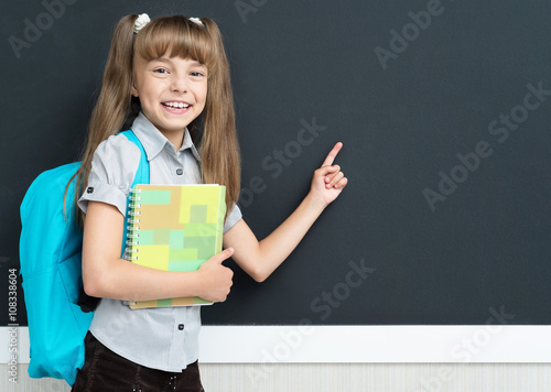 Back to school concept - schoolgirl with backpack
