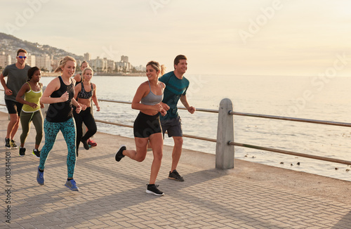 Young runners workout along a seaside promenade