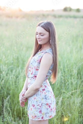 Beautiful girl field green meadow in summer park delicate dress, enjoying leisure, fashion style, glamor life, student at a bright sunny day.