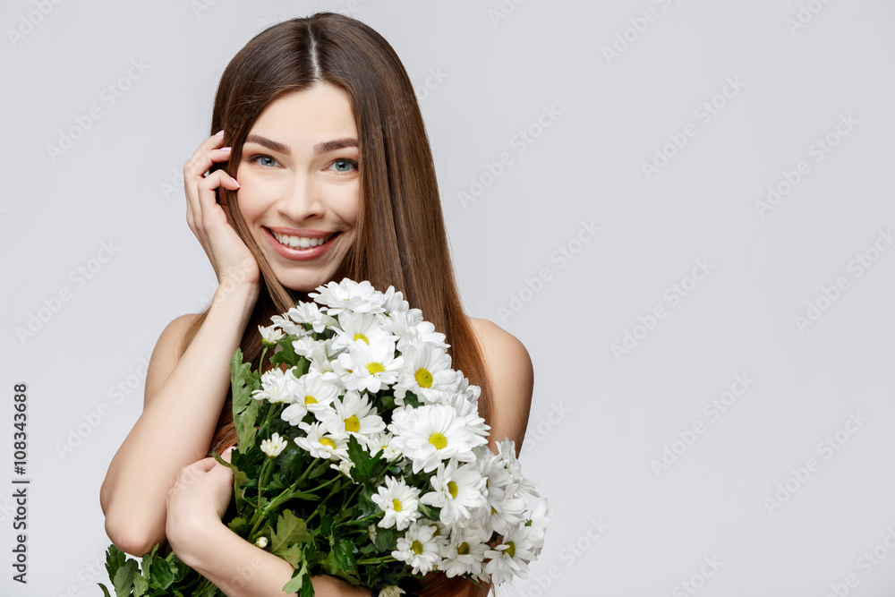Beautiful Woman with Clean Fresh Skin holding flowers Beautiful Woman with Clean Fresh Skin holding flowers