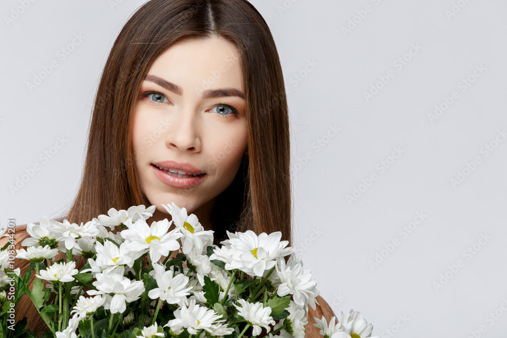 Beautiful Woman with Clean Fresh Skin holding flowers Beautiful Woman with Clean Fresh Skin holding flowers