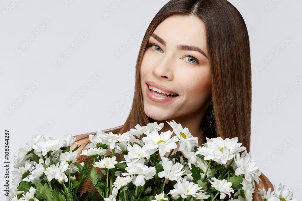 Beautiful Woman with Clean Fresh Skin holding flowers Beautiful Woman with Clean Fresh Skin holding flowers