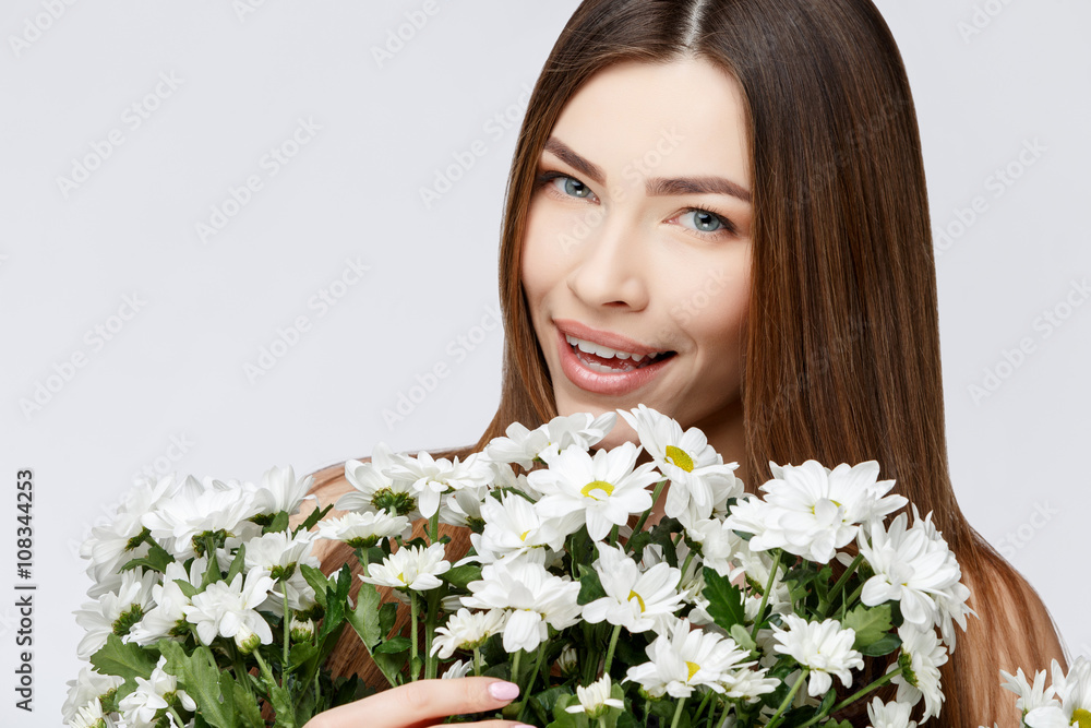 Beautiful Woman with Clean Fresh Skin holding flowers Beautiful Woman with Clean Fresh Skin holding flowers