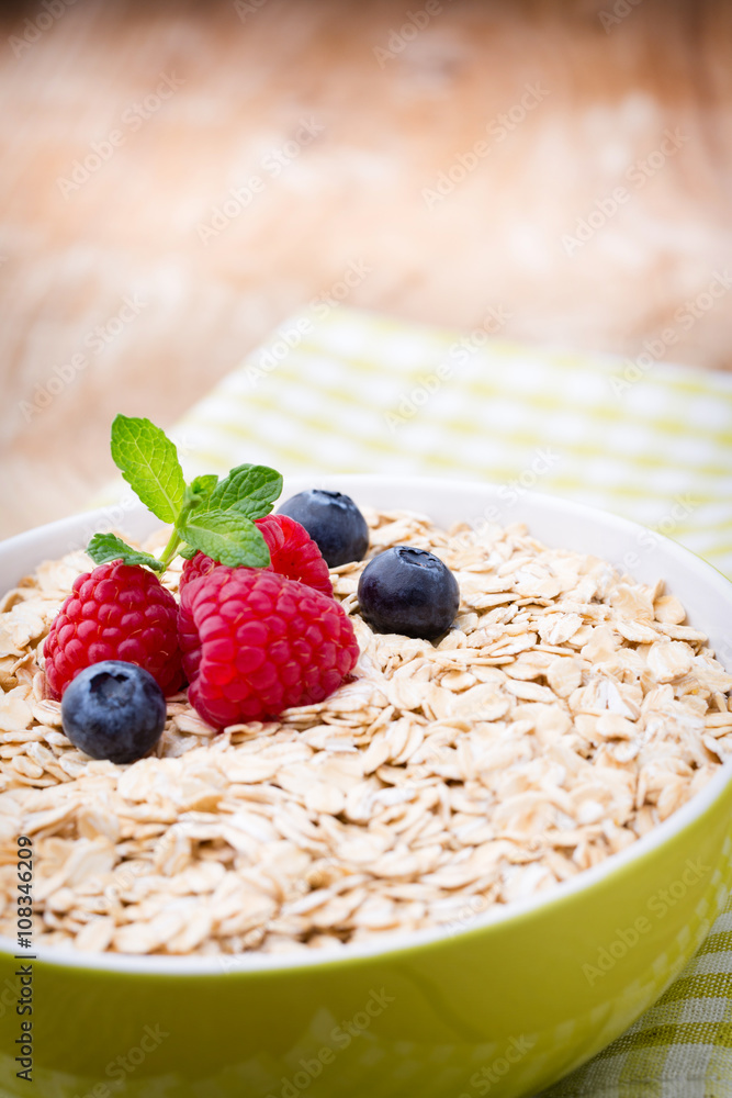 Oatmeal porridge with berries. Raspberries and blueberries. Oatmeal porridge with berries. Raspberries and blueberries.