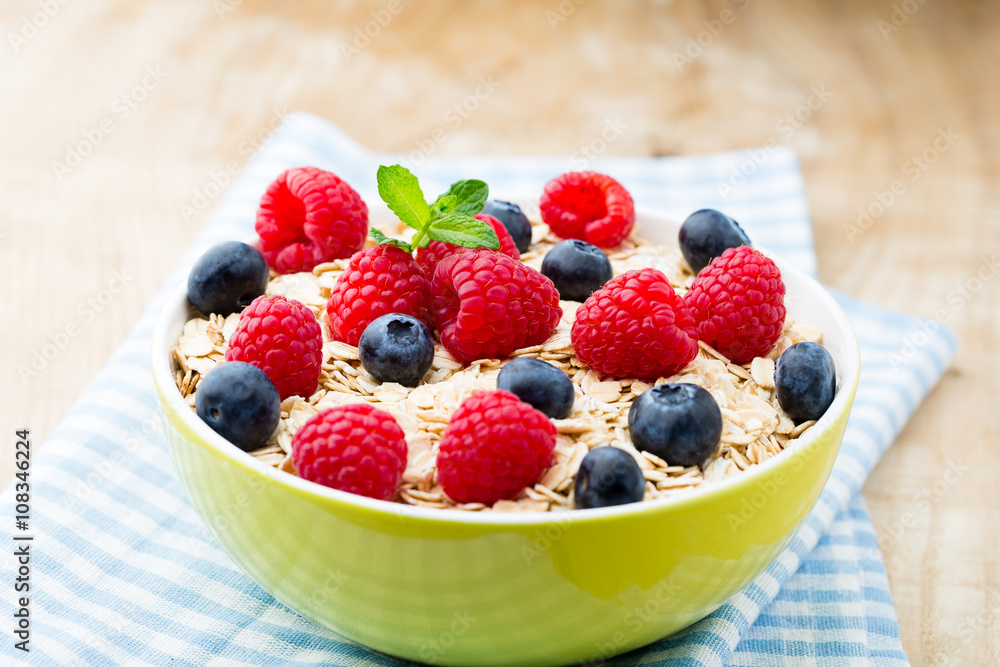 Oatmeal porridge with berries. Raspberries and blueberries. Oatmeal porridge with berries. Raspberries and blueberries.