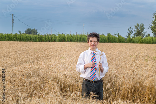 Handsome boy in a golden wheat field © Vivida Photo PC