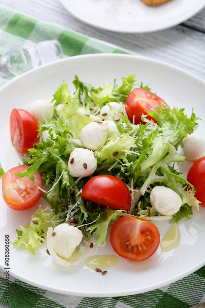 fresh salad with tomatoes on white plate fresh salad with tomatoes on white plate