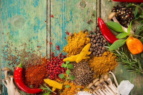 Fototapet Various colorful spices on wooden table