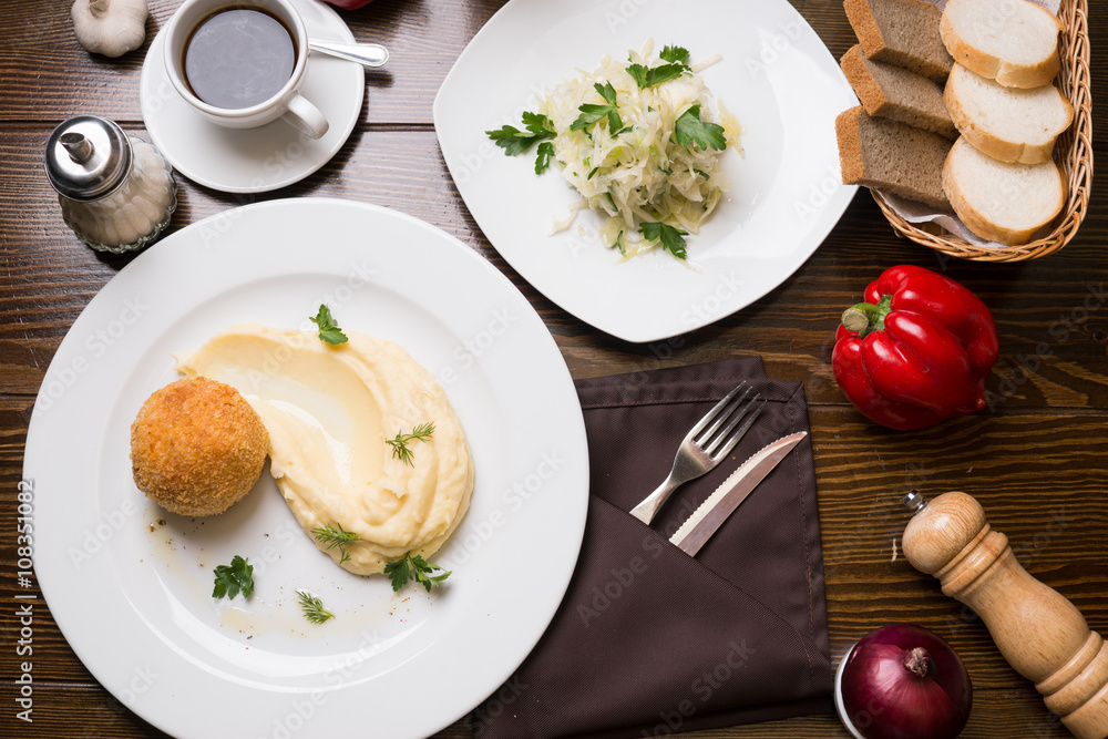 Meat in Breadcrumbs, Cabbage Salad And Cup of Coffee On A Table Meat in Breadcrumbs, Cabbage Salad And Cup of Coffee On A Table