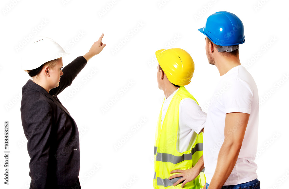 Female engineer talking with two builders Female engineer talking with two builders