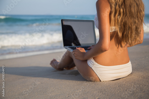 girl with a laptop on the beach freelance
