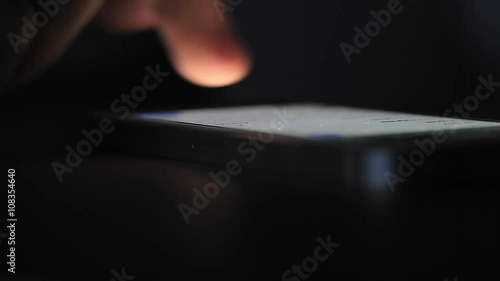 Mobile Phone on Table Pushed and Swiped by Finger.