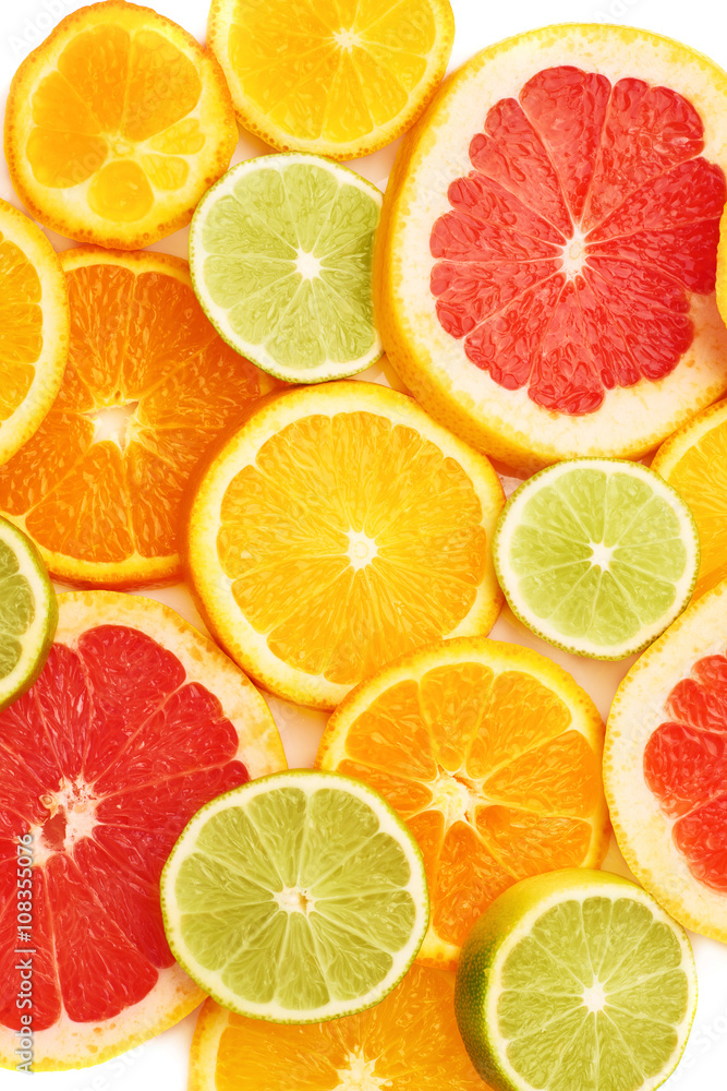 Surface covered with citrus sliced fruits over white isolated background Surface covered with citrus sliced fruits over white isolated background