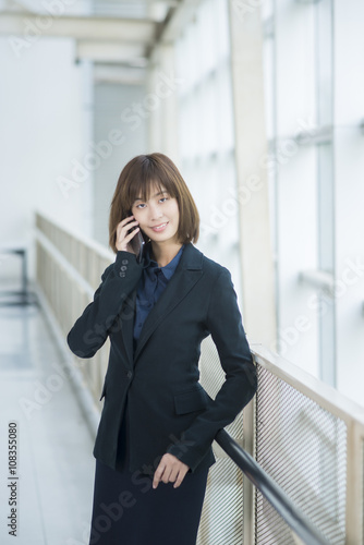 Attractive asian business woman using on smartphone outside Offi
