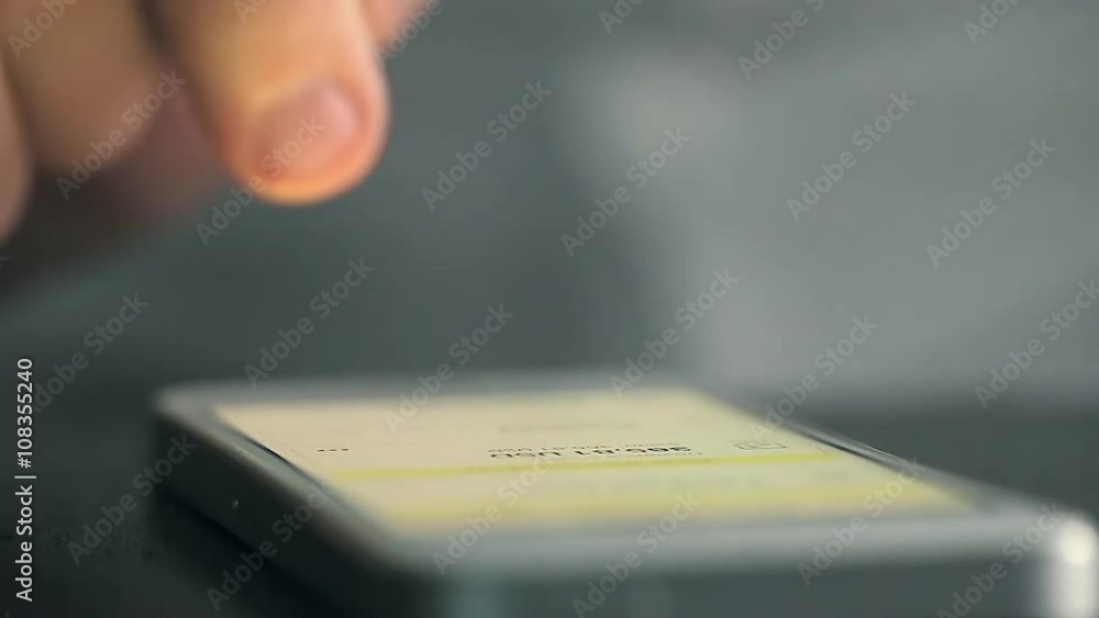 Mobile Phone on Table Pushed and Swiped by Finger. Mobile Phone on Table Pushed and Swiped by Finger.