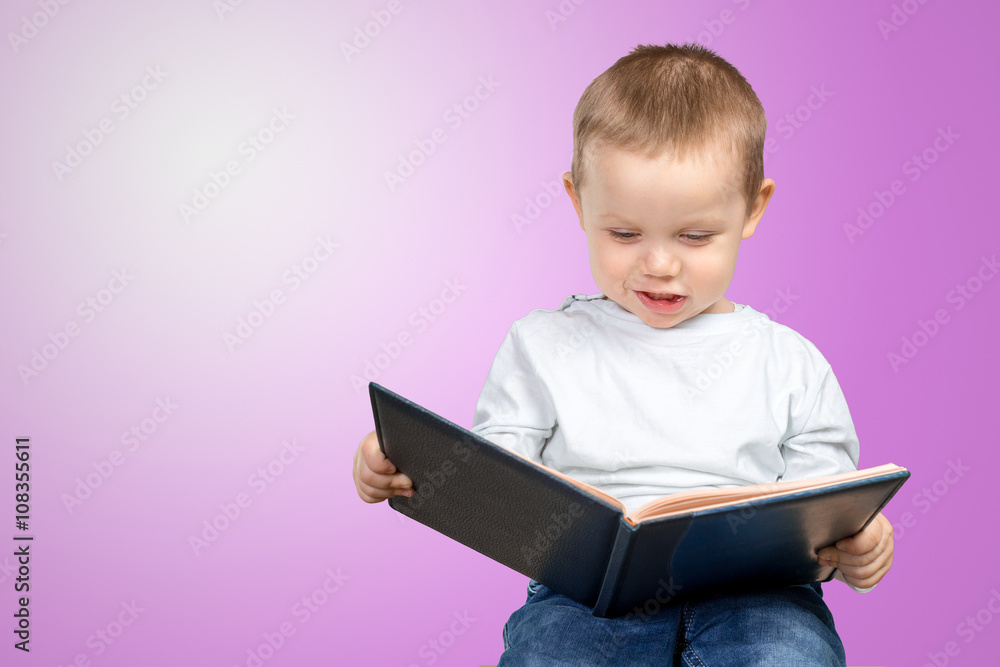 A young school boy is holding a blue book A young school boy is holding a blue book