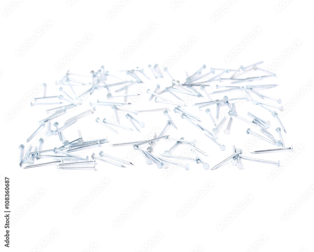 Scattered nails over surface isolated over white background