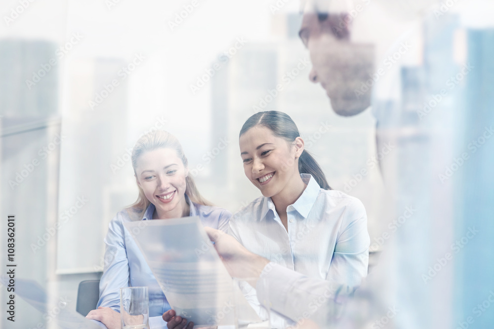group of smiling businesspeople meeting in office group of smiling businesspeople meeting in office