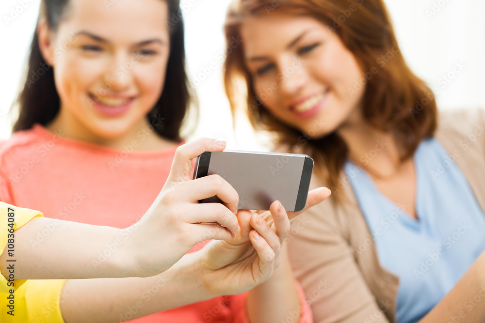 close up of friends taking selfie with smartphone close up of friends taking selfie with smartphone