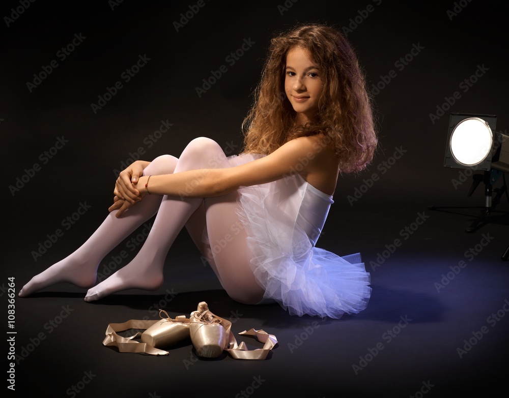 Fototapeta premium Smiling ballet student on floor