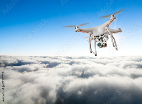 Fototapeta Naklejka Na Ścianę i Meble -  Drone for industrial works flying above clouds