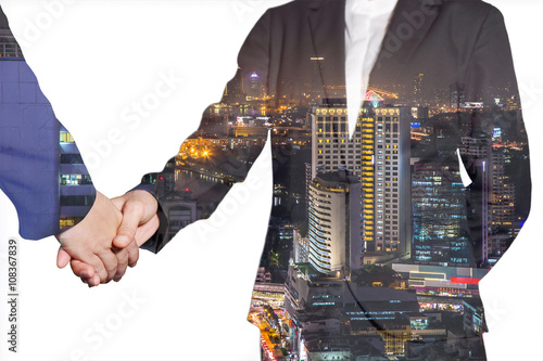 Double exposure of business women handshake night street and night cityscape as commitment and congratulation concept.