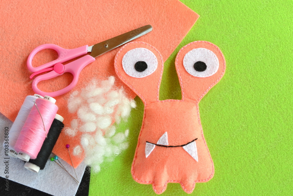Naklejka premium Funny felt monster, a children's toy, sewing kit for a felt monster