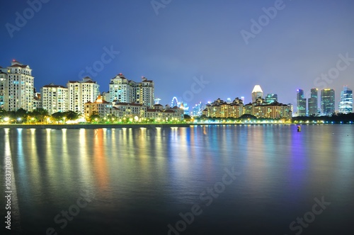 Greenery by Kallang River  south of Singapore   with downtown skyline and colourful reflections in the background..