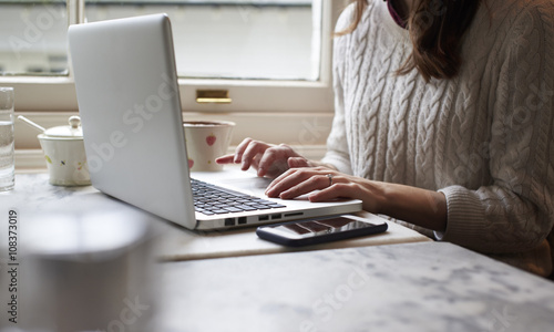 Close Up Of Young Woman Working Remotely On Laptop