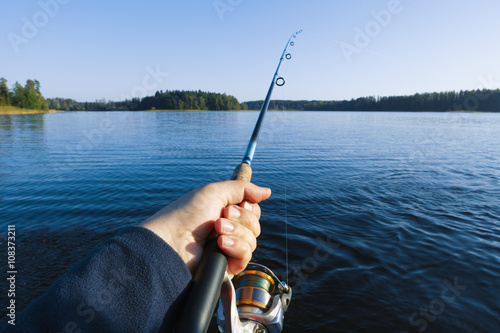 fishing on a lake at sunset