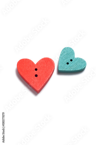 Close up of two wooden heart-shape buttons